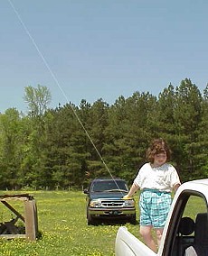 Aubrey flies her kite from truck bed