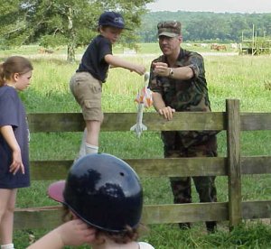 Jerry, in National Guard togs, fetchs a rocket